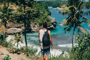 Praias para fazer bate e volta em sp: imagem mostra jovem admirando a praia.